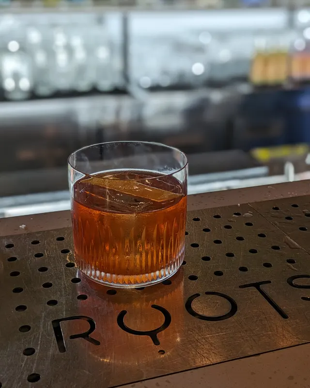Old Fashioned on the drip tray of a bar counter