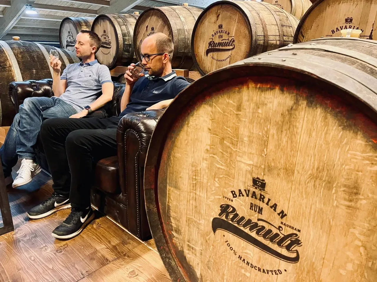 Christoph and Hendrik Fröhlich tasting rum in a barrel warehouse